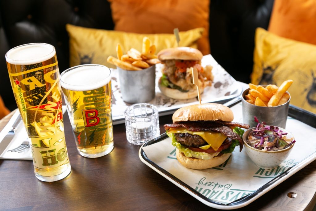 Crispy burger with fries and coleslaw on a tray