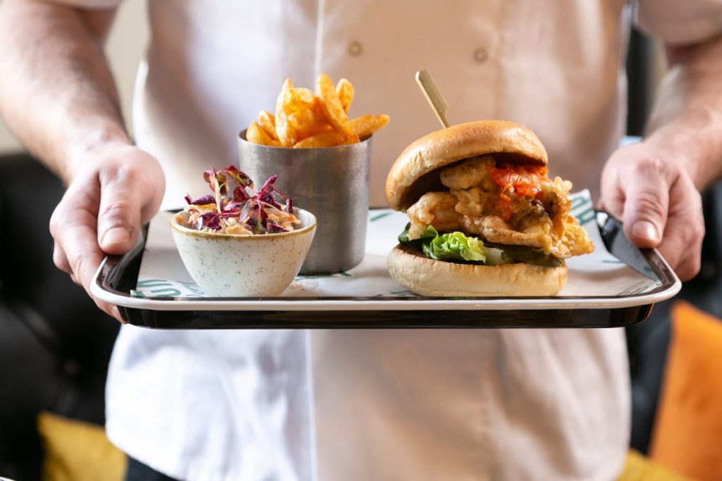 Crispy chicken burger served with fries and coleslaw