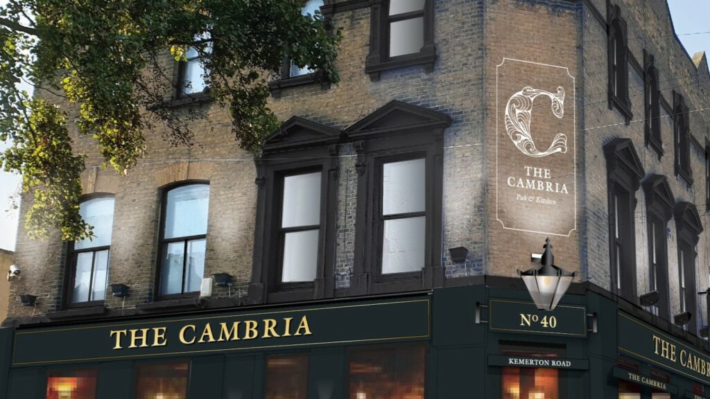 Exterior of The Cambria pub with brickwork, signage and large windows